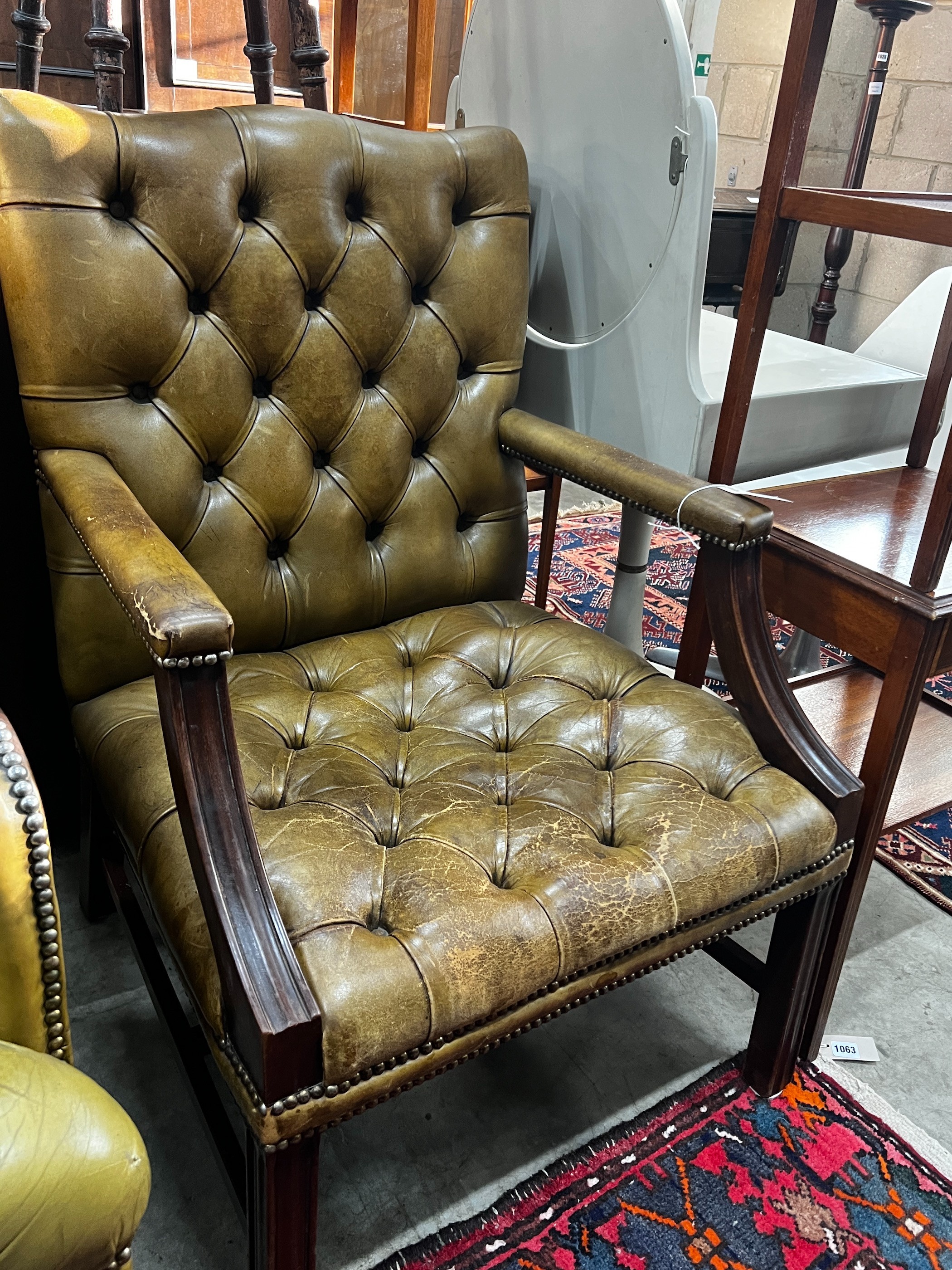 A George III style buttoned green leather library chair, width 64cm, depth 58cm, height 97cm